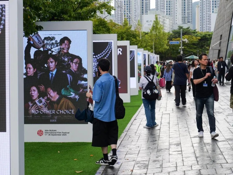 Festival-goers walk past movie posters outside the Busan Cinema Center on Wednesday. Photo by Thomas Maresca/UPI