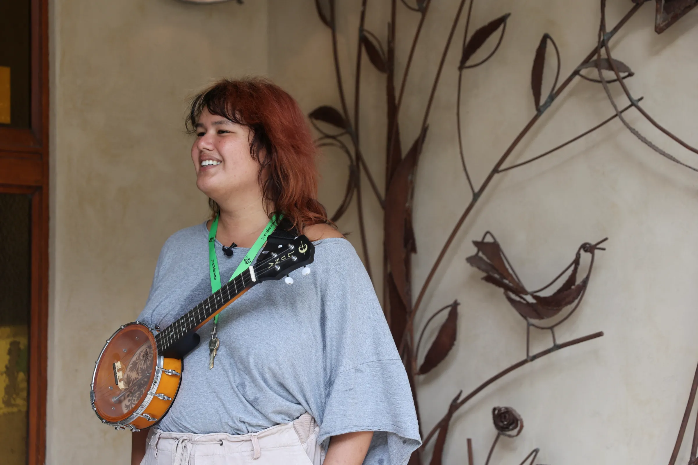 Veronica Clifford Carlos, a U.S. trans woman seeking asylum in the Netherlands, reacts as she stands with a musical instrument, in Heerlen, Netherlands September 2, 2025. REUTERS/Charlotte Van Campenhout