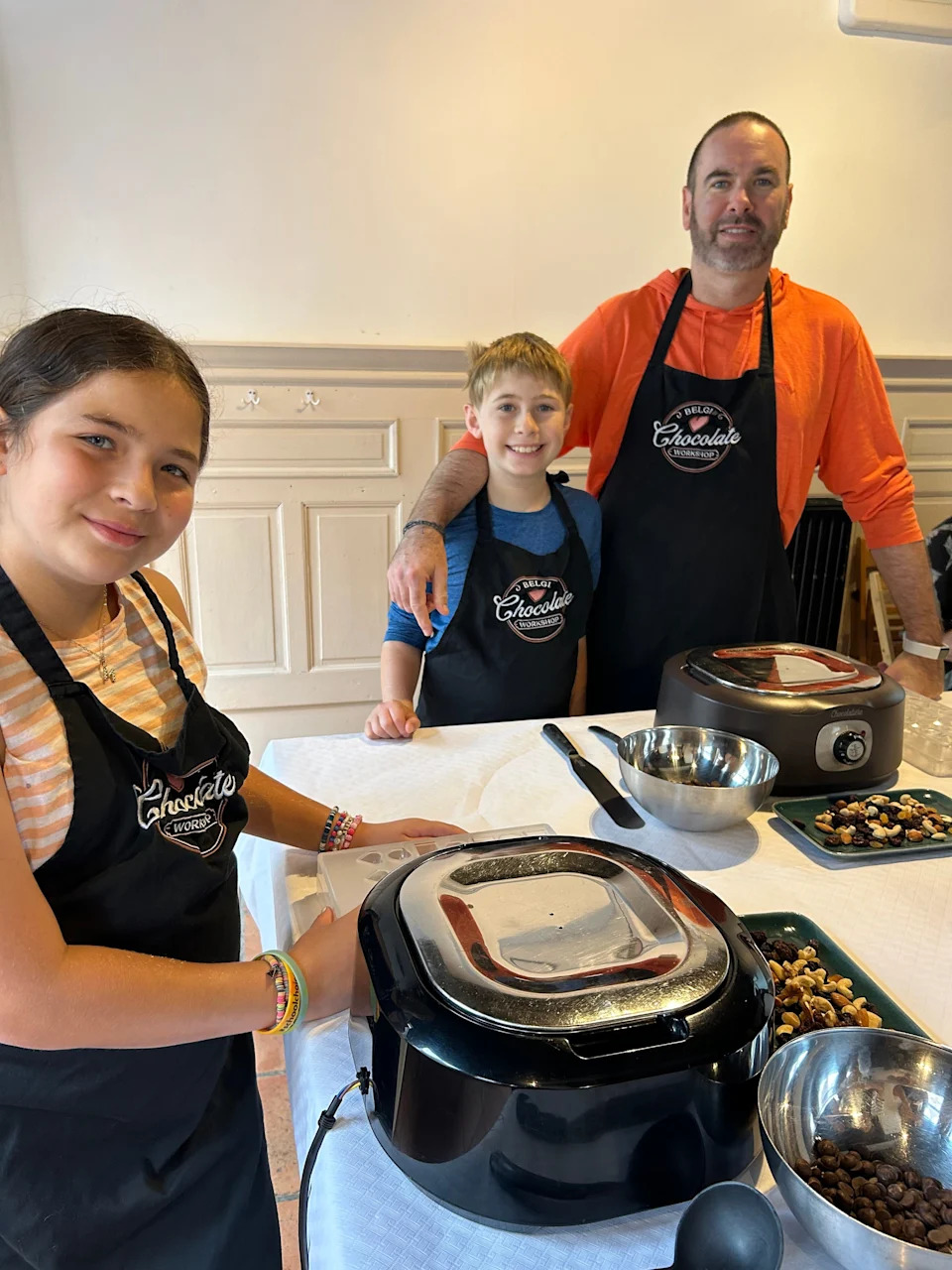 The author's husband and kids taking a chocolate class in Bruges.