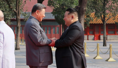 North Korean leader Kim Jong-un, right, holds hands in greeting with Chinese President Xi Jinping before the Victory Day parade in Beijing on Sept. 3. [NEWS1]