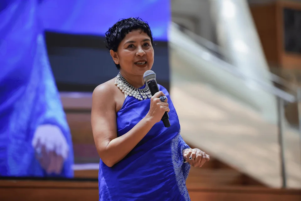 ItsRainingRaincoats founder Dipa Swaminathan speaking at the charity’s 10th anniversary event on Sept 21.