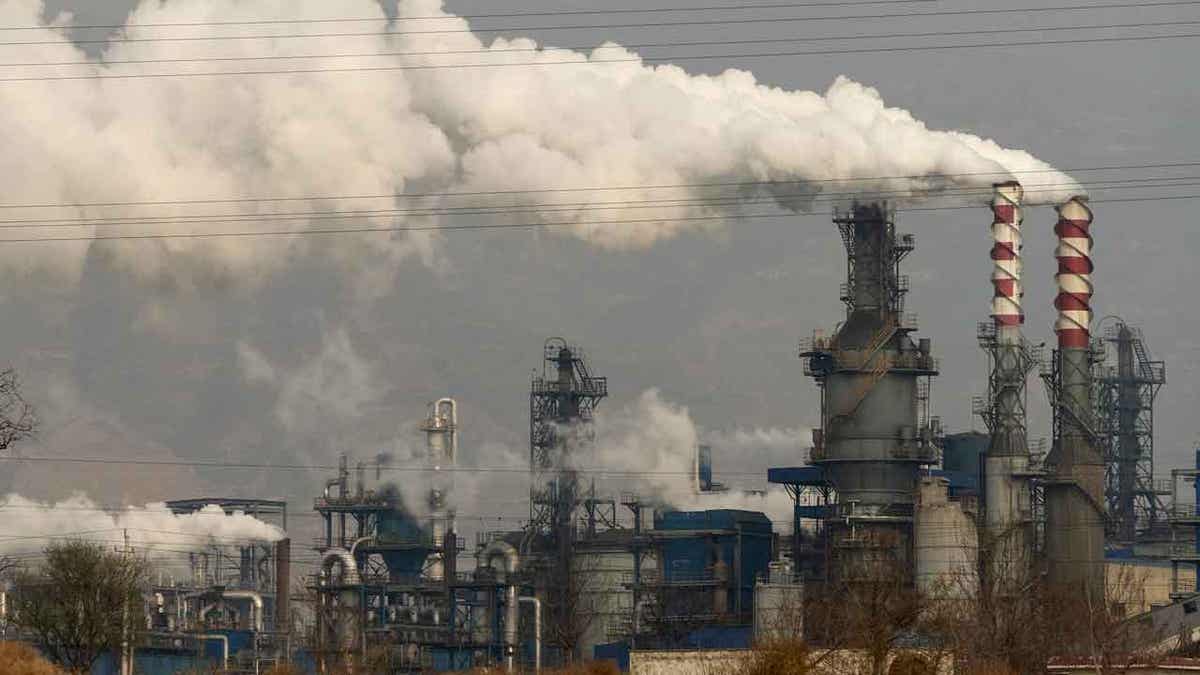 Smoke and steam rise from a coal processing plant in China.