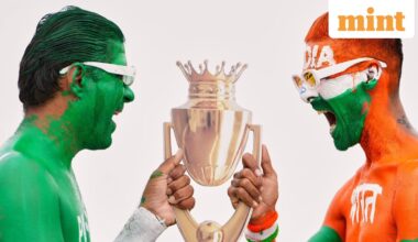 Indian cricket fans, with their bodies painted in the colors of Indian and Pakistan flags, pose for the media with a cutout image of the Asia Cup trophy in Ahmedabad, India. (AP Photo/Ajit Solanki)