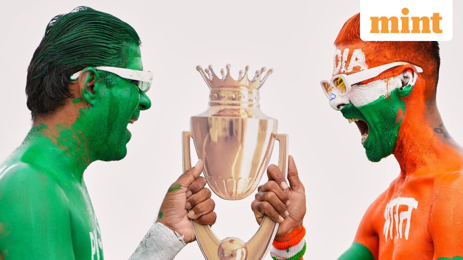 Indian cricket fans, with their bodies painted in the colors of Indian and Pakistan flags, pose for the media with a cutout image of the Asia Cup trophy in Ahmedabad, India. (AP Photo/Ajit Solanki)