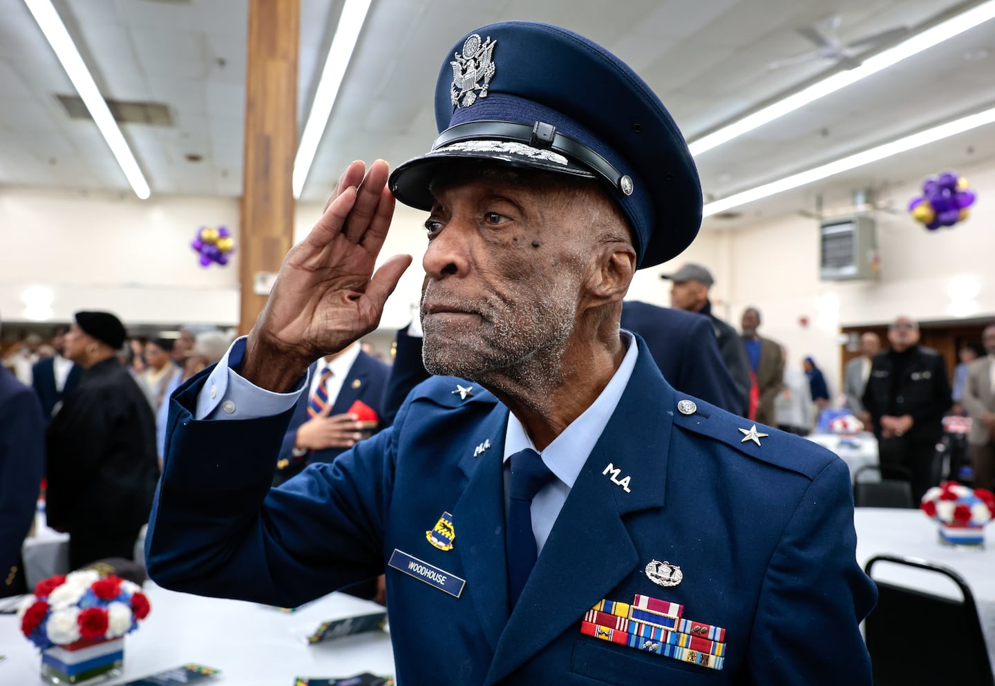 Brigadier General Enoch “Woody” Woodhouse II, a Tuskegee Airman and Roxbury native, saluted during the national anthem at the Black Veterans Appreciation Brunch in Boston in 2024.