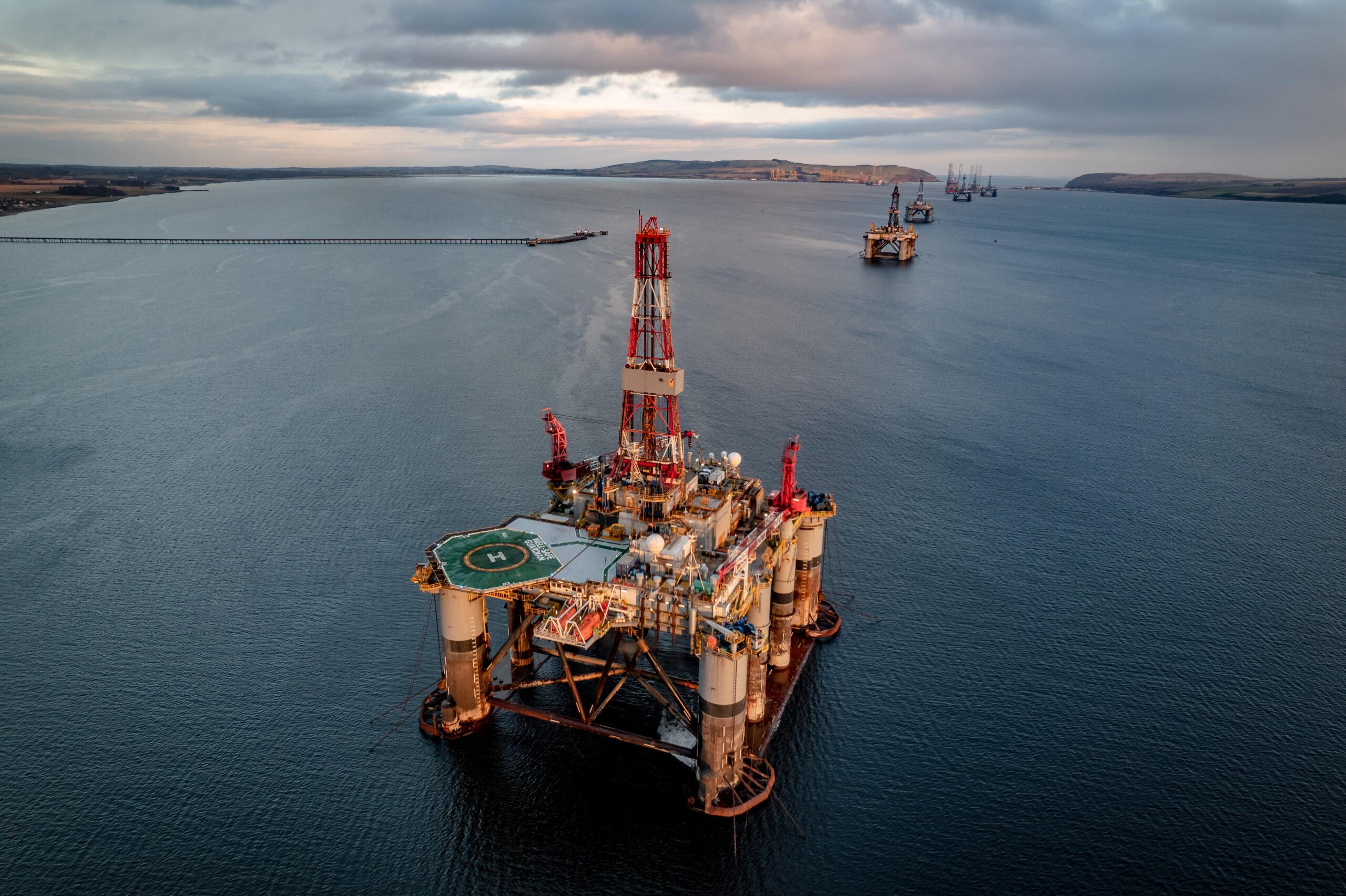 Oil rigs on a body of water. 