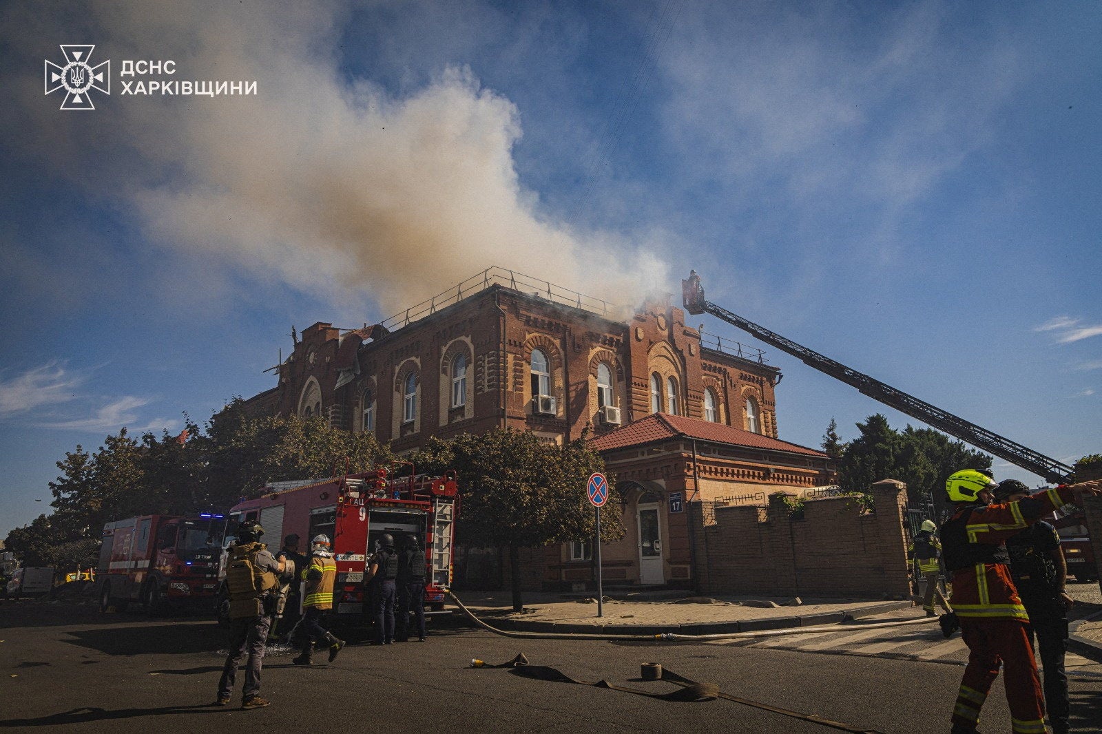 Firefighters work at the site of a building of a pharmaceutical university hit by a Russian drone strike in Kharkiv