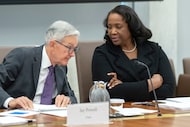 Federal Reserve Governor Lisa Cook talks with Federal Reserve Chairman Jerome Powell before...