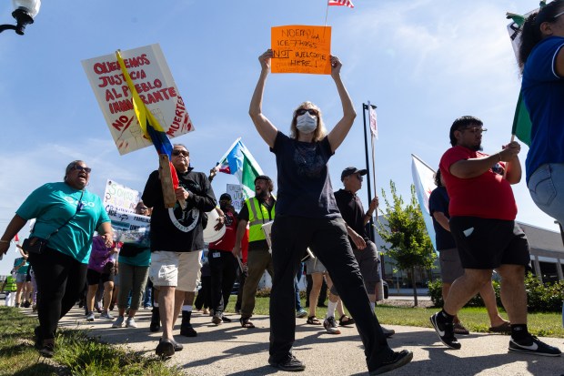 Protesters march, play music and chant during a walk protesting...