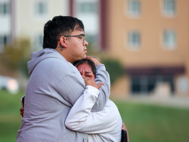 Ismael Cordova-Clough, left, hugs Delani Henrnadez, both members of a volunteer patrol group in the Elgin area, as Hernandez cries after witnessing a man pulled from his truck and detained by federal agents along Route 31 on Sept. 16, 2025, in Elgin. As Hernandez cried she said "I couldn't stop them, I couldn't stop them." It was her first day on patrol with the group which posts and live streams any suspected ICE activities in and around Elgin. (Stacey Wescott/Chicago Tribune)