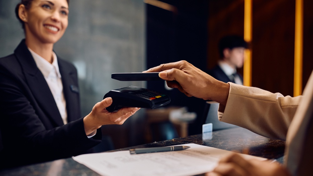 A person is paying with a credit card at a reception.