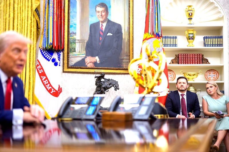 White House Deputy Chief of Staff Taylor Budowich (2nd-R) and White House press secretary Karoline Leavitt (R) listen as U.S. President Donald Trump (L) speaks
