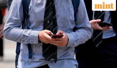 A file photo of youngsters looking at their phones in Melbourne as Australia. Tech companies including WhatsApp and Reddit as well as streaming giant Twitch and gaming firm Roblox could be among more than a dozen sites added to Australia's social media ban for under-16s, the country's regulator said on September 24, 2025.