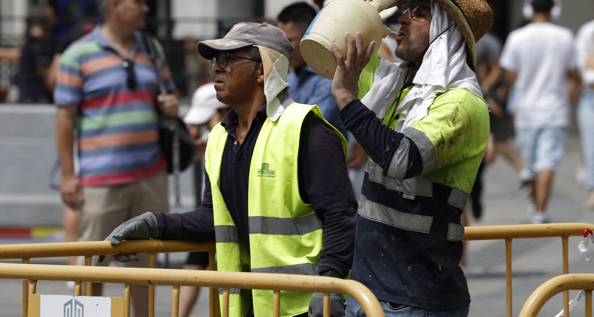 A worker drinks water from a botijo, a Spanish traditional earthenware drinking jug, to fight the heat in the midst of a heat wave in Madrid on Aug. 9, 2023. Credit: Javier Soriano/AFP via Getty Images