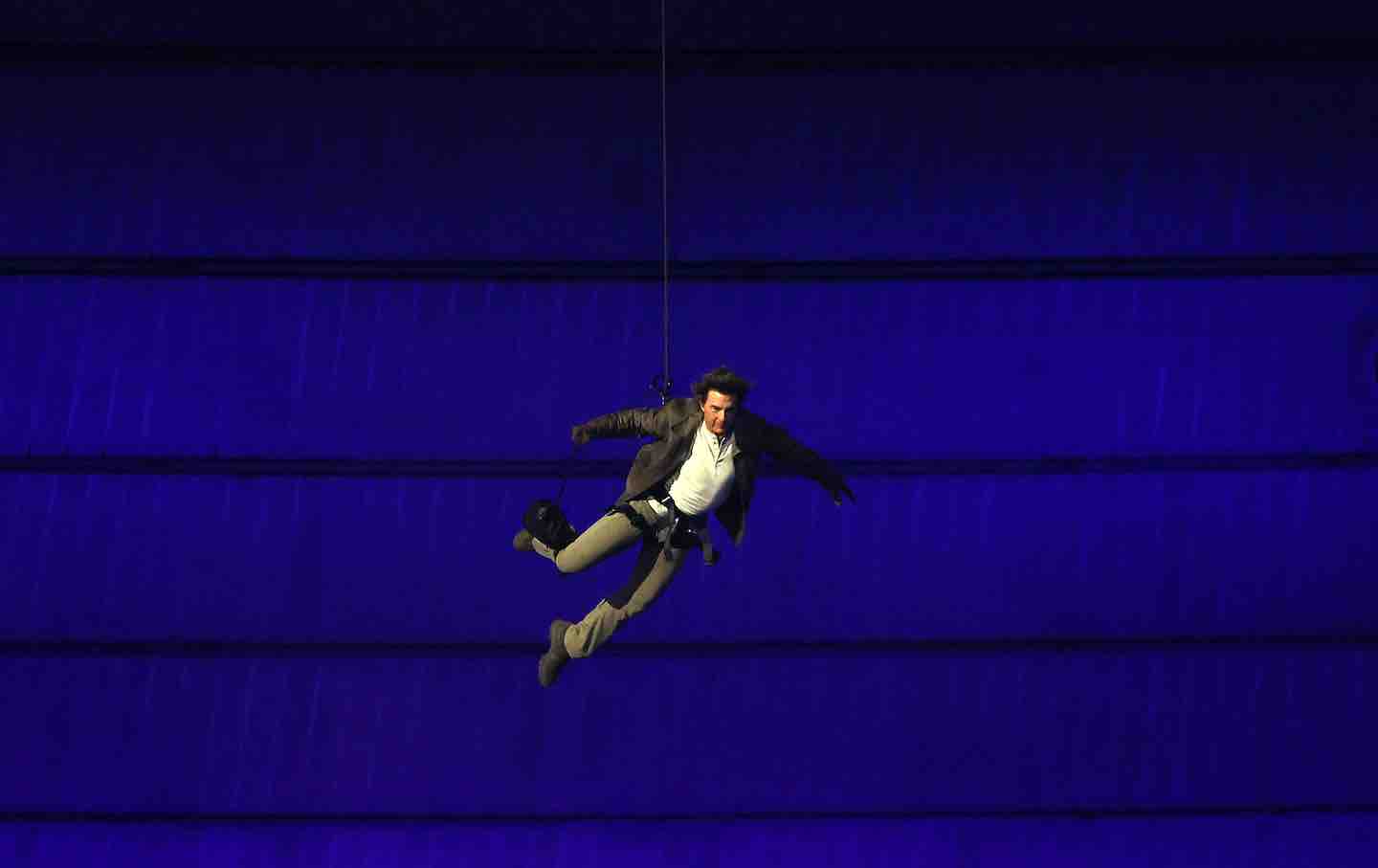 Tom Cruise repels into the Stade de France during the Closing Ceremony of the Olympic Games in Paris, 2024.