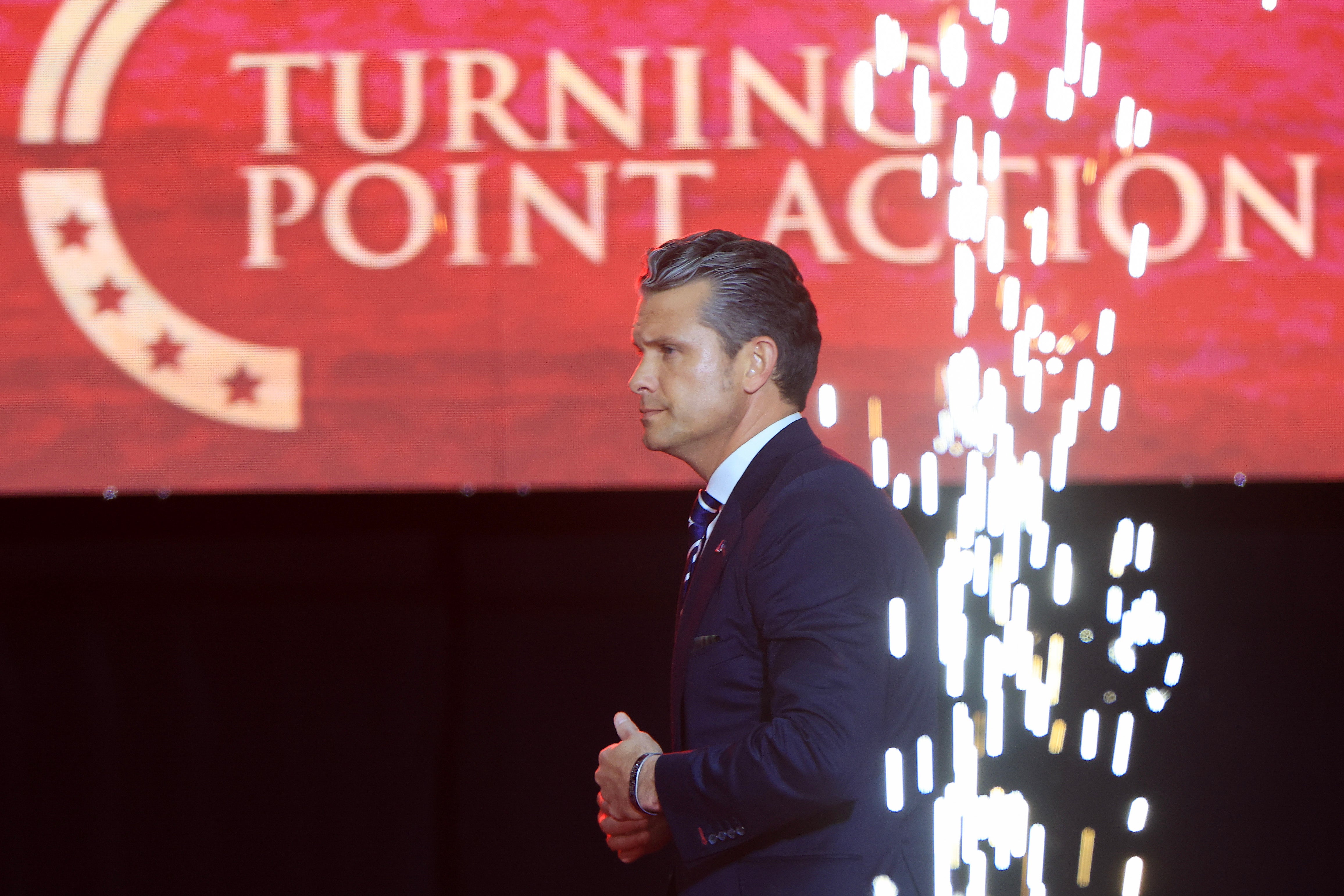 Secretary of War Pete Hegseth onstage during the memorial service for political activist Charlie Kirk