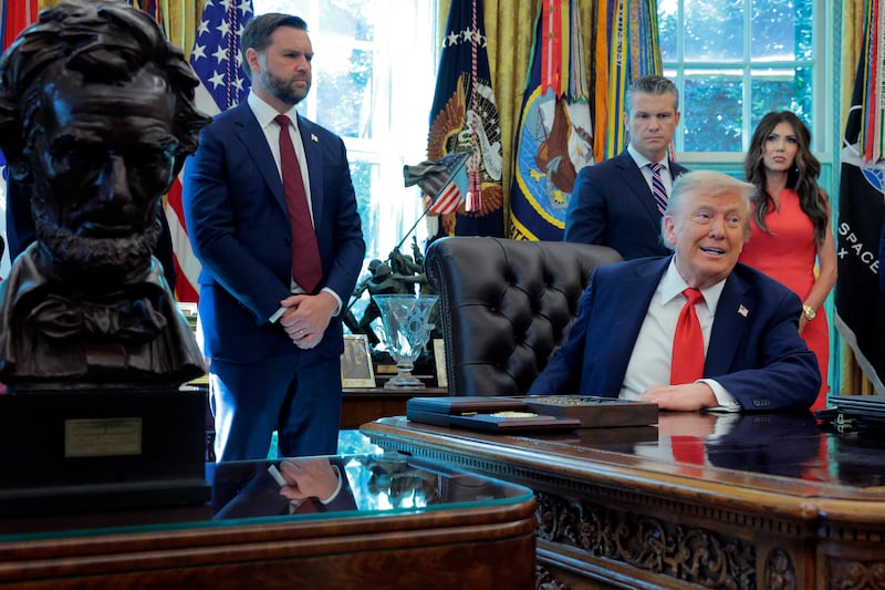 President Donald Trump talks to journalists after signing executive orders in the Oval Office including ending cashless bail in the District of Columbia and mandating prosecution for people who desecrate the American flag. Looking on is (L-R) Vice President JD Vance, Defense Secretary Pete Hegseth and Homeland Security Secretary Kristi Noem, as welll as a bust of Abraham Lincoln. Picture: Chip Somodevilla/Getty Images