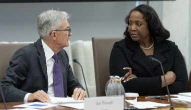 Federal Reserve Chairman Jerome Powell, left, talks with Board of Governors member Lisa Cook, right, during an open meeting of the Board of Governors at the Federal Reserve, June 25, 2025, in Washington. (AP Photo/Mark Schiefelbein, File)