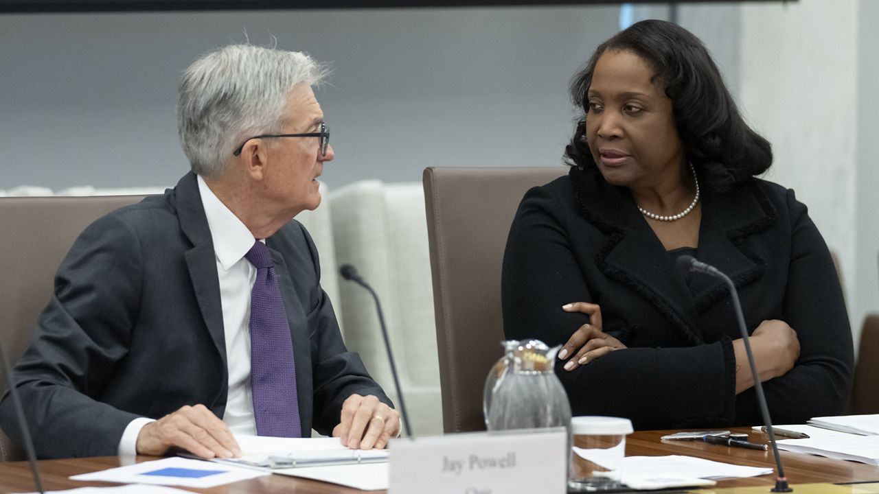Federal Reserve Chairman Jerome Powell, left, talks with Board of Governors member Lisa Cook, right, during an open meeting of the Board of Governors at the Federal Reserve, June 25, 2025, in Washington. (AP Photo/Mark Schiefelbein, File)