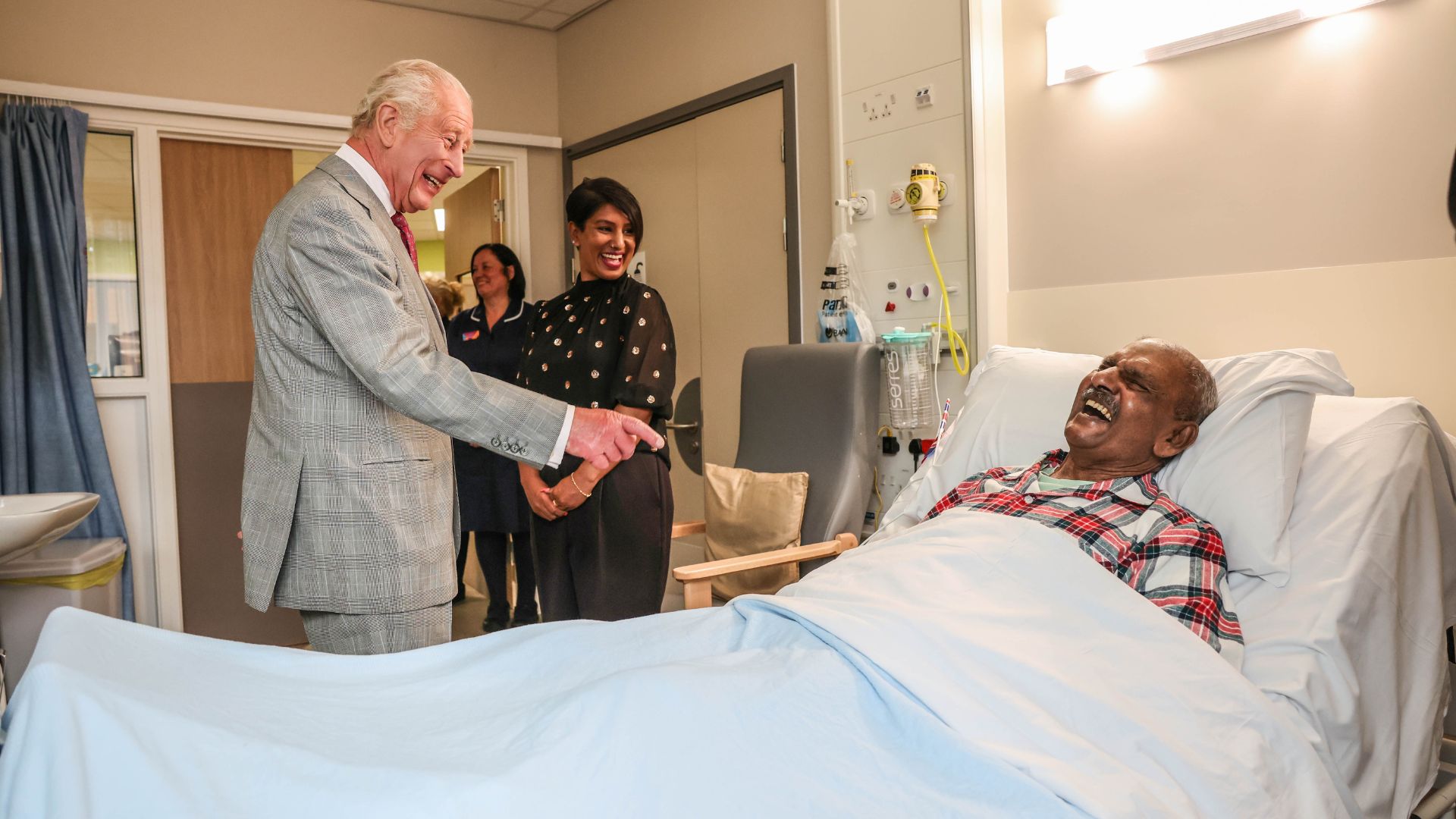 King Charles III talks with cancer patient Matthew Shinda during a visit to a ward when he officially opened Midland Metropolitan University Hospital