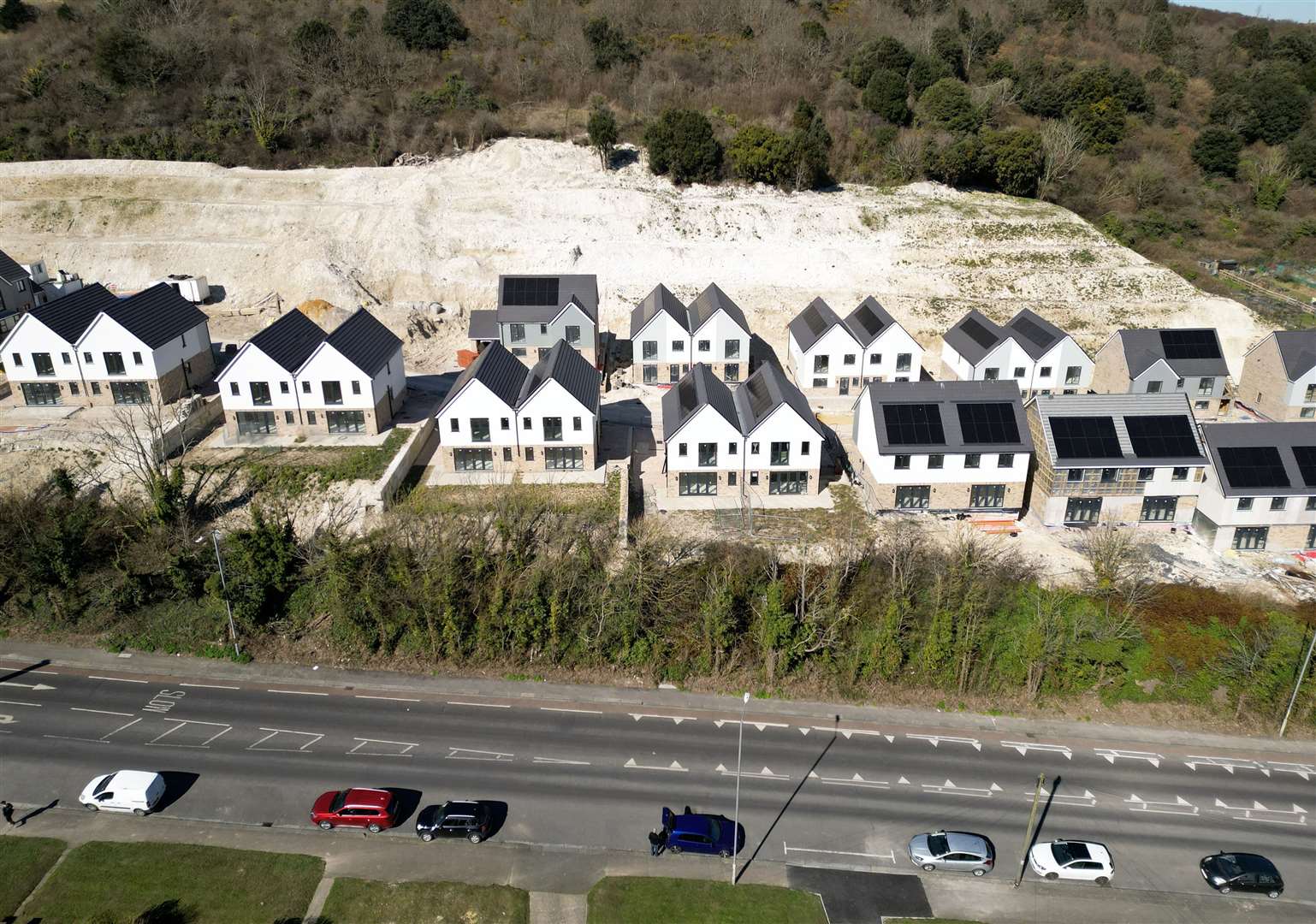 The unfinished Enzo Homes development in Folkestone Road, Dover, has left a “chalk scar” on the hillside. Picture: Barry Goodwin