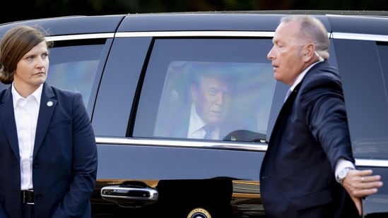 US President Donald Trump (C) sits in his car "The Beast"(AFP)