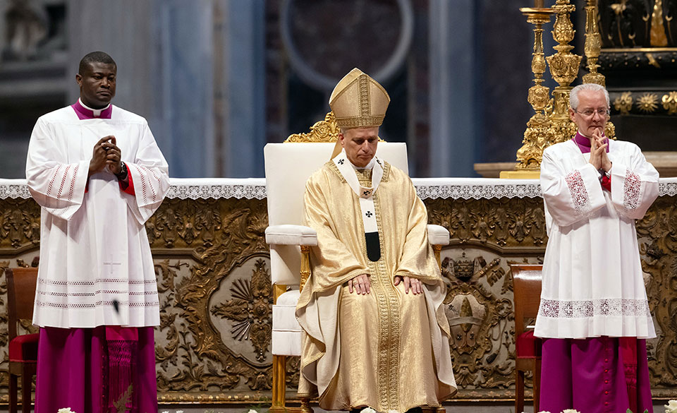 people in vestments praying