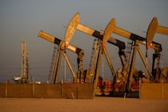 A file photo shows an array of pumpjacks operating near the site of a new oil and gas well...