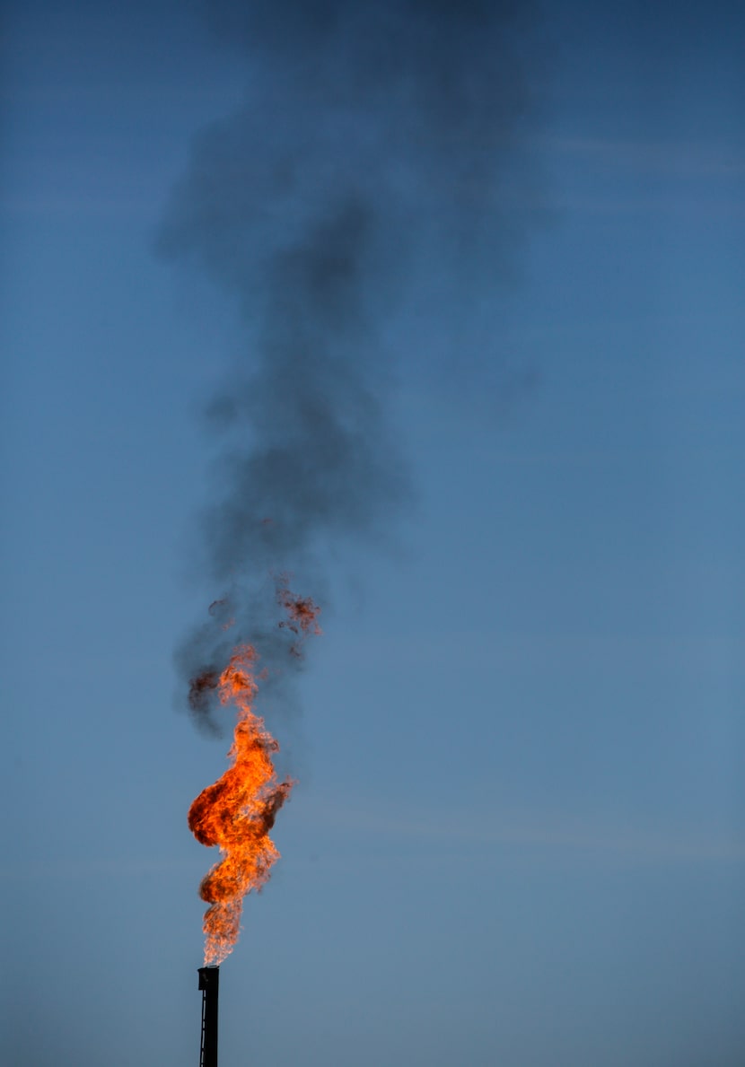 Black smoke billows from an oil storage tank flare stack in Texas' Permian Basin on Nov. 1,...