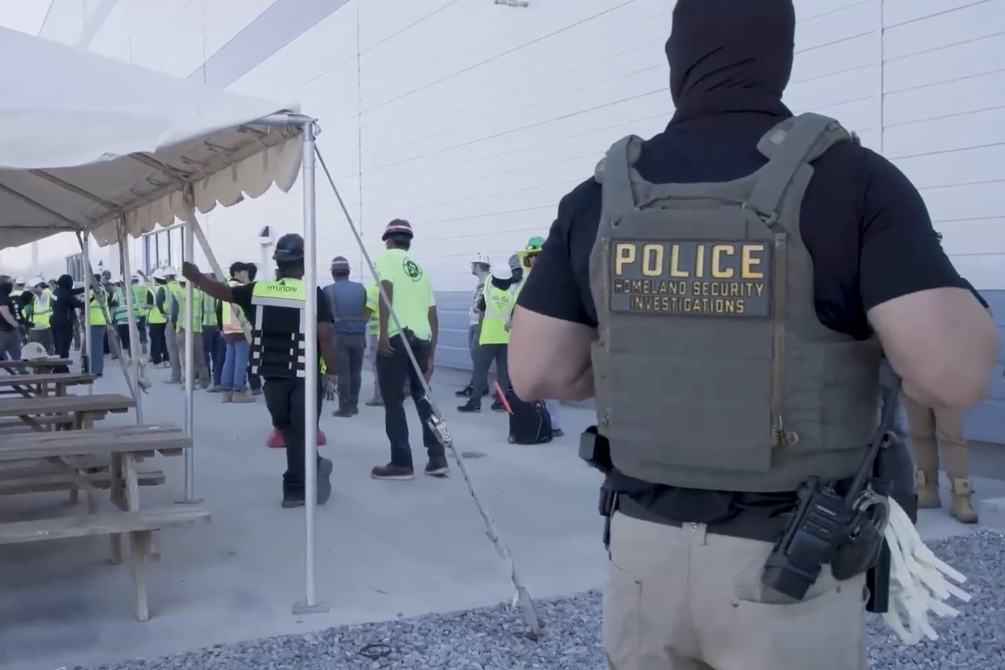 Manufacturing plant employees being escorted outside the Hyundai Motor Group’s electric vehicle plant, Thursday, Sept. 4, 2025, in Ellabell, Ga.