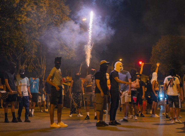 TORREPACHECO, SPAIN - JULY 14: Protesters wearing masks and balaclavas launch fireworks during the fourth night of riots on July 14, 2025 in Torrepacheco, in the province of Murcia, Spain. The violent confrontation was sparked by the beating of an elderly resident the night before, allegedly by assailants who were of North African origin. The crowd that gathered tonight reportedly chased peopled they suspected to be immigrants and clashed with members of Spain's Guardia Civil. (Photo by Olmo Blanco/Getty Images)