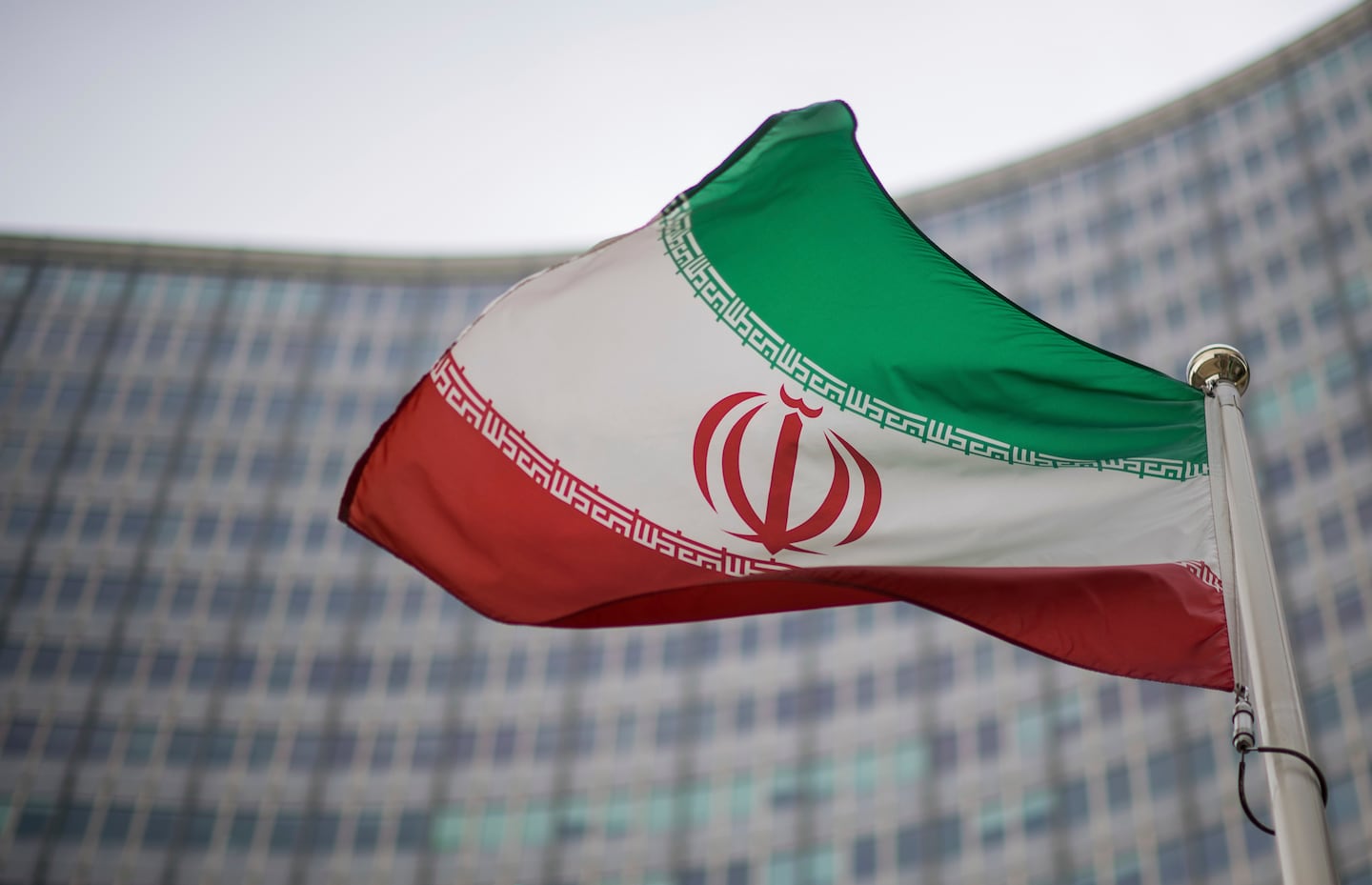 A national flag of Iran waved in front of the building of the International Atomic Energy Agency, IAEA, in Vienna. The confidential report said Iran and the IAEA have not reached an agreement on resuming inspections of sites affected by Israeli and US bombing in June.