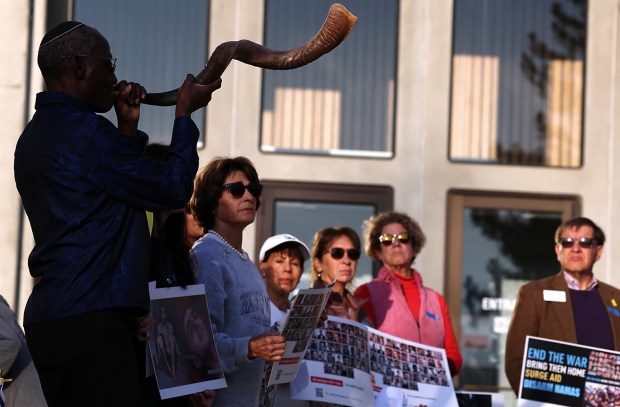 Akindele Akiva Bankole blasts a mournful note on a shofar (ritual ram's horn) as about 25 people gathered Friday morning on the county courthouse steps to mark the 700th day of captivity for the Israeli hostages held by Hamas. In 2023, as part of the Oct. 7 attacks that initiated the latest Israel-Hamas war, Hamas and other Palestinian militant groups abducted 251 people from Israel to the Gaza Strip, including children, women and elderly people. There are 48 hostages remaining in captivity in the Gaza Strip and according to Israeli intelligence, at least 25 of the remaining hostages are dead. (Shmuel Thaler - Santa Cruz Sentinel)