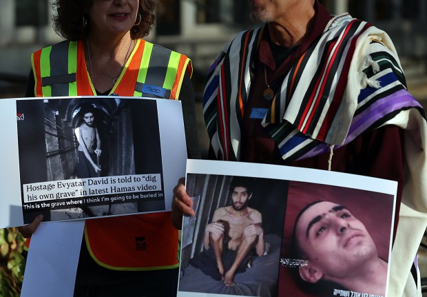 Anastasia Torres-Gil, left, and Rabbi Eli Cohen hold photos of...