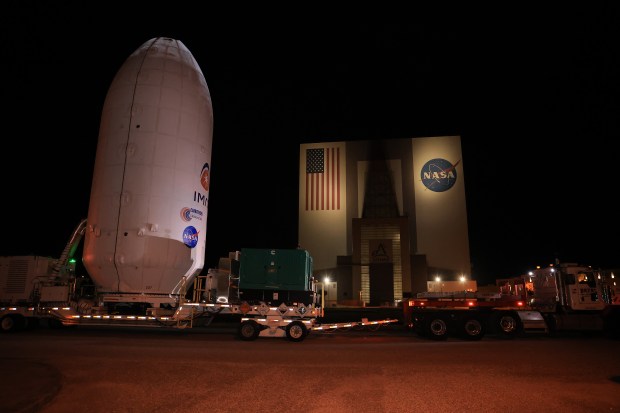Workers transport NASA's IMAP (Interstellar Mapping and Acceleration Probe) spacecraft...