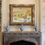 A beautifully framed artwork above a stone mantel.