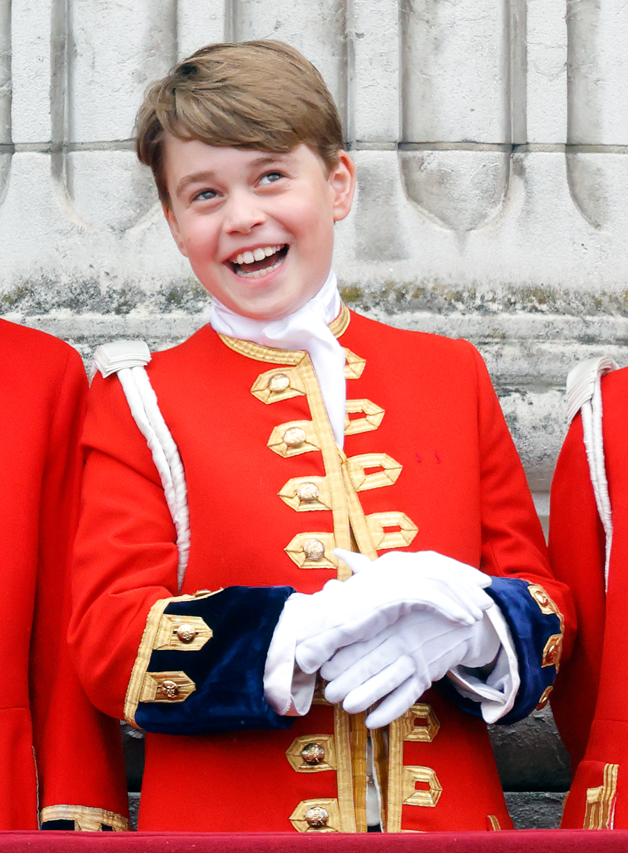 Prince George laughing in a red uniform