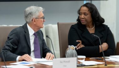 Federal Reserve Chairman Jerome Powell (left) talks with Board of Governors member Lisa Cook during an open meeting of the Board of Governors in June.