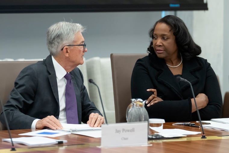 Federal Reserve Chairman Jerome Powell (left) talks with Board of Governors member Lisa Cook during an open meeting of the Board of Governors in June.