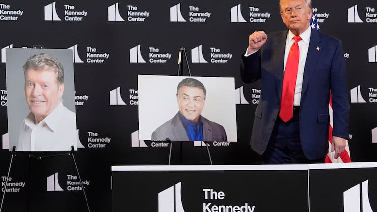 US President Donald Trump stands beside photos of Kennedy Center Honors nominees at the Kennedy Center, August 13, 2025, in Washington.
