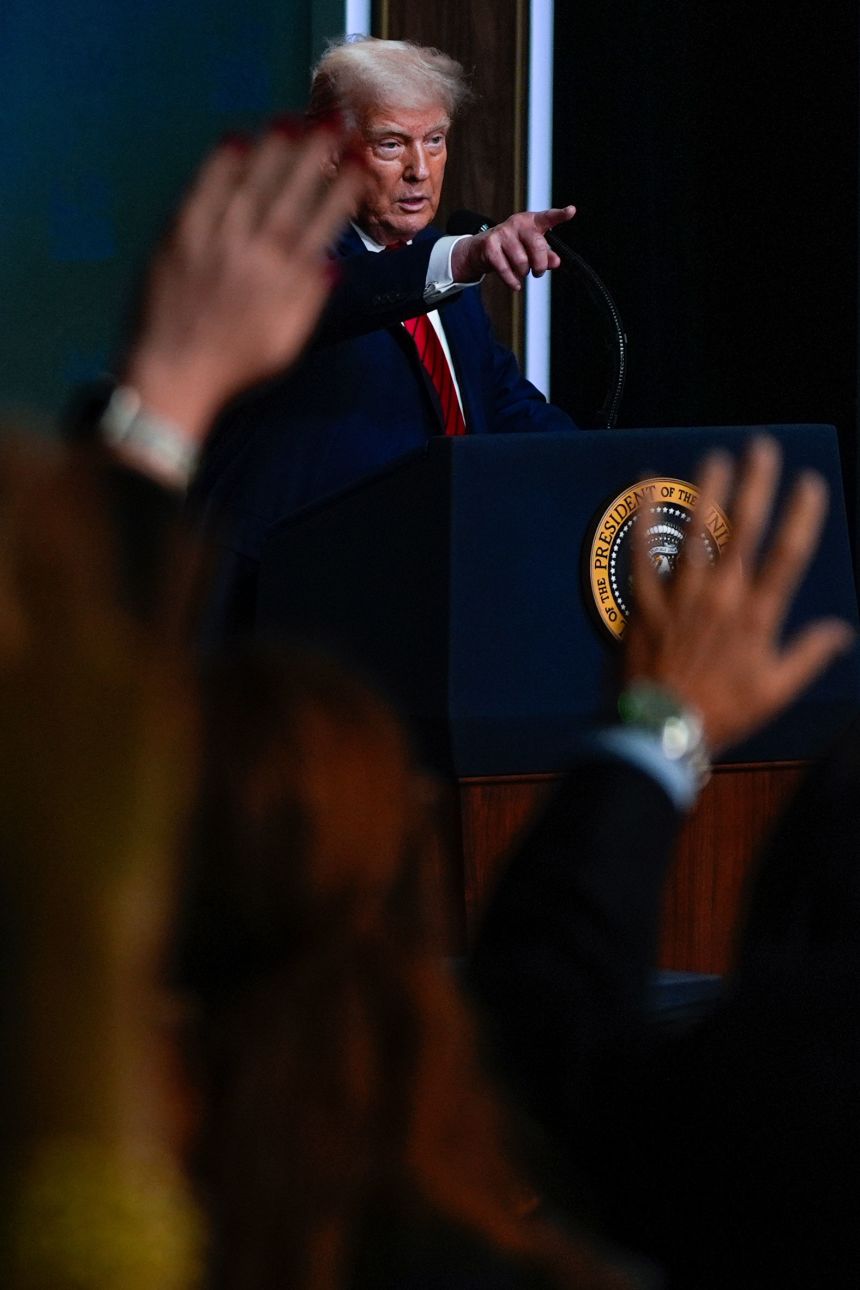 President Donald Trump answers questions from reporters after signing an executive order on Tuesday.