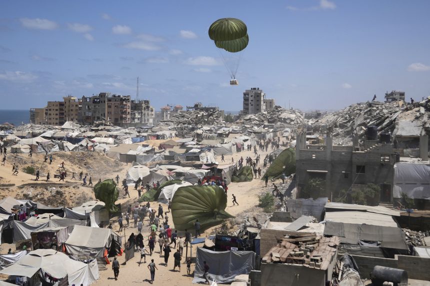 Palestinians rush to collect humanitarian aid airdropped into Gaza City on Thursday, August 7, 2025