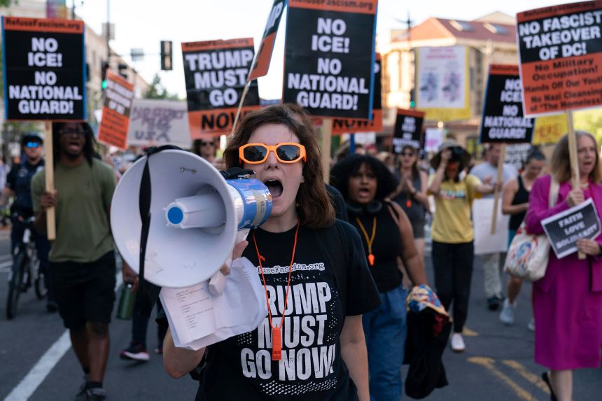 People protest against the presence of ICE agents and National Guard troops, in the Columbia Heights neighborhood of Washington, DC, on August 22.