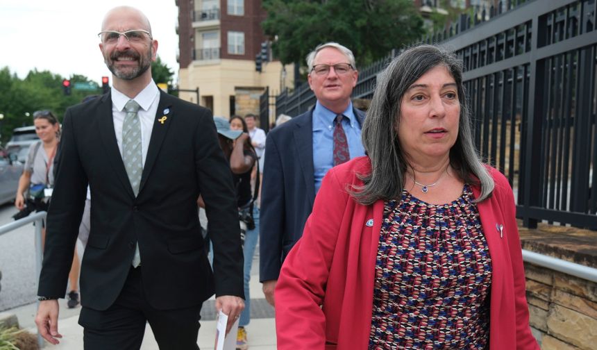 Dr. Debra Houry, right, Dr. Demetre Daskalakis, left, and Dr. Daniel Jernigan gather as workers and supporters rally outside the CDC headquarters, Thursday, August 28, in Atlanta. The three resigned after President Donald Trump called for the ouster of CDC Director Susan Monarez.