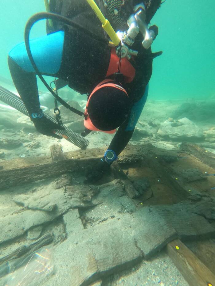 Archaeologists Examining Wood Plank