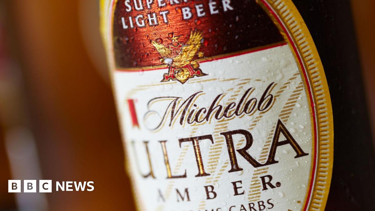 A close-up of a beer bottle label, reading Michelob Ultra in brown print.