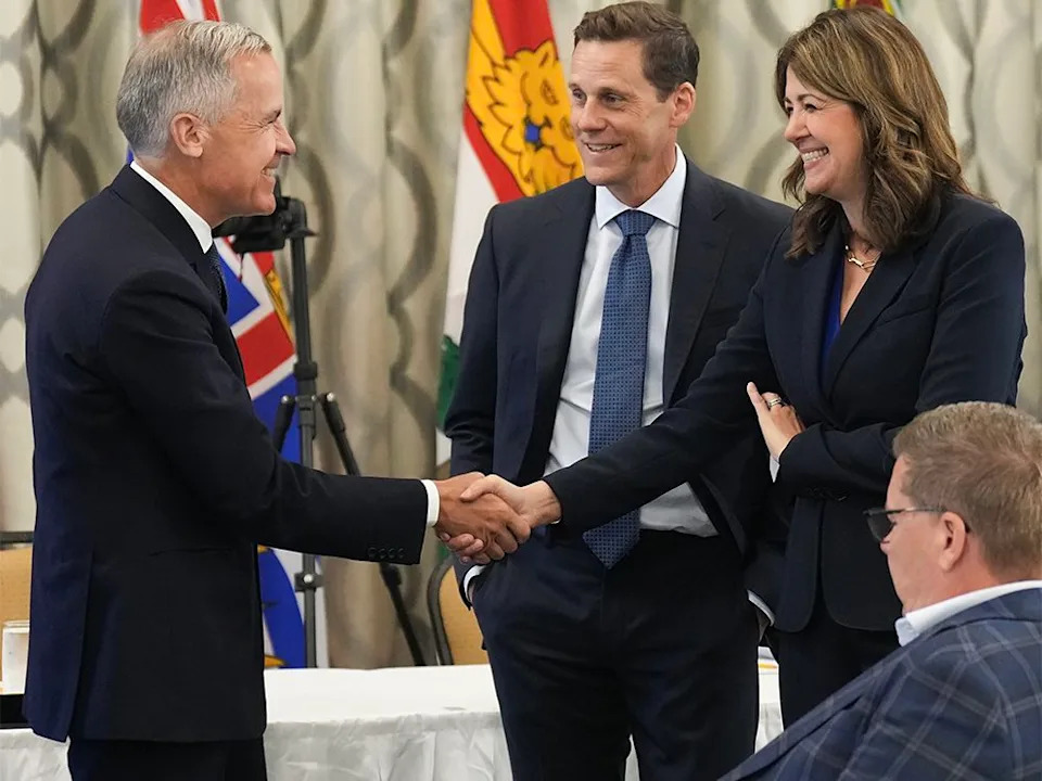  Canadian Prime Minister Mark Carney, left, greets Alberta Premier Danielle Smith, right, during the 2025 summer meetings of Canada’s Premiers at Deerhurst Resort in Huntsville, Ont., on Tuesday, July 22, 2025.