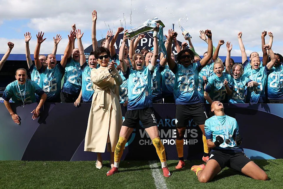 Owner Michele Kang celebrates with the London City Lionesses players after winning promotion to the top-flight