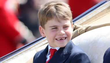 Prince Louis smiles as he travels by carriage during Trooping the Colour 2025