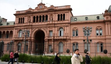 People walk past Casa Rosada presidential palace in Buenos Aires on September 8, 2025.